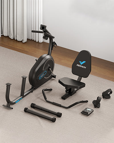 Despiece de bicicleta estática reclinada Merach que muestra el asiento ergonómico, pedales, monitor digital y estructura de acero para un montaje sencillo en casa